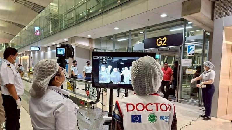 Airport health authorities wearing protective masks monitor passengers from international flights arriving at Suvarnabhumi International Airport in Bangkok, Thailand, January 25, 2026, following the implementation of health screening measures for passengers arriving from West Bengal, India, amid reports of a Nipah virus outbreak.