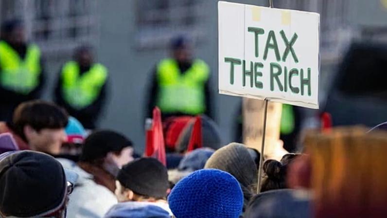 A climate justice protest at the World Economic Forum in Davos, where participating corporations were accused of fuelling crises and profiting from them.