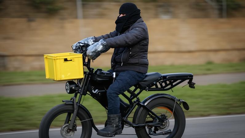 Person wrapped up from the cold zooming along on a fatbike