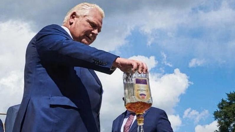 Ontario’s premier, Doug Ford, empties a bottle of Crown Royal whisky in Kitchener, Ontario, on 2 September 2025.