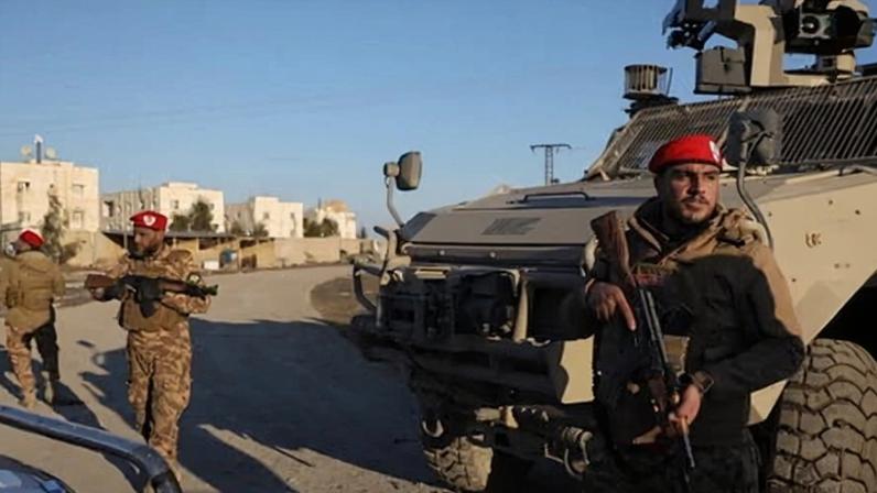 Syrian government forces outside al-Aqtan prison on the outskirts of Raqqa, north-eastern Syria on Monday, a day after the Syrian president announced a ceasefire with the SDF.