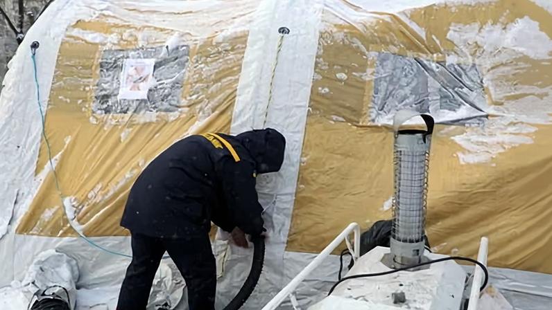 A State Emergency Service worker sets up a heating tent installed in the Desnianskyi district of Kyiv, Ukraine.