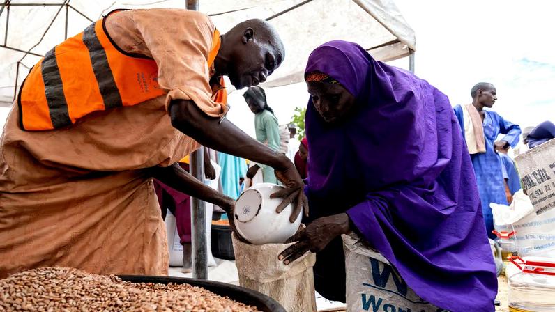 Yaanama Abba, a 45-year-old mother of six children, receives pinto beans distributed by WFP in Mafa LGA, Borno State, Nigeria, July 16, 2025. Damilola Onafuwa, WFP Nigeria Communications Service/Handout via REUTERS/File Photo