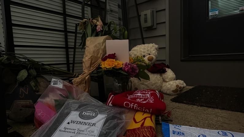 Flowers and other items sit on the front porch of Spencer and Monique Tepe's home in Columbus, Ohio.