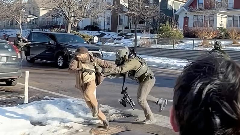An video still shows Alex Pretti, left, being grabbed by a federal officer in Minneapolis on 13 January, 11 days before he was shot dead.