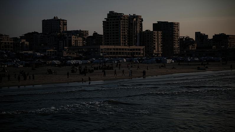Palestinians spend time on the Mediterranean coast at sunset in Gaza City on 16 Jan 2026. Meanwhile, the beach in the Gaza Strip has become a makeshift camp for displaced people whose homes were destroyed during the war, as it is the only place where tents can be accommodated amidst the widespread destruction and rubble covering the city.