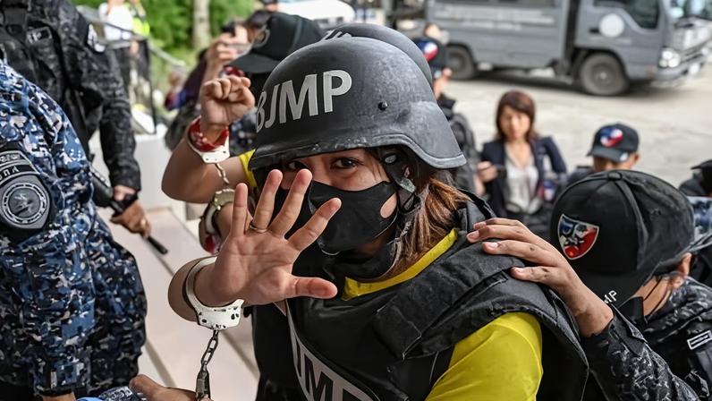 Journalist Frenchie Mae Cumpio gestures as she arrives at Tacloban court in Leyte island, the Philippines, on 22 January 2026.