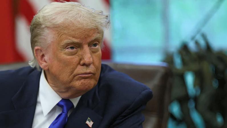 U.S. President Donald Trump looks on as he signs executive orders and proclamations in the Oval Office at the White House