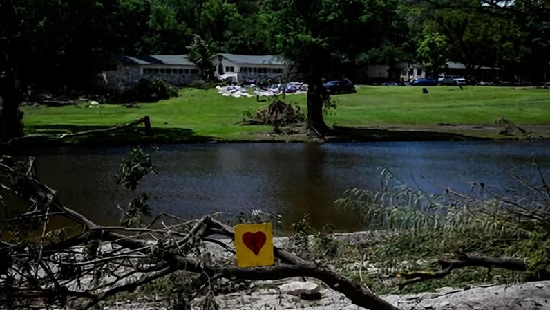 A painted broken heart is seen near Camp Mystic along the Guadalupe River in Hunt, Texas, on 8 July 2025.
