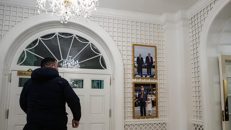 A photograph of Donald Trump with Vladimir Putin, above another of Trump and a grandchild, in the Palm Room of the White House on Tuesday.