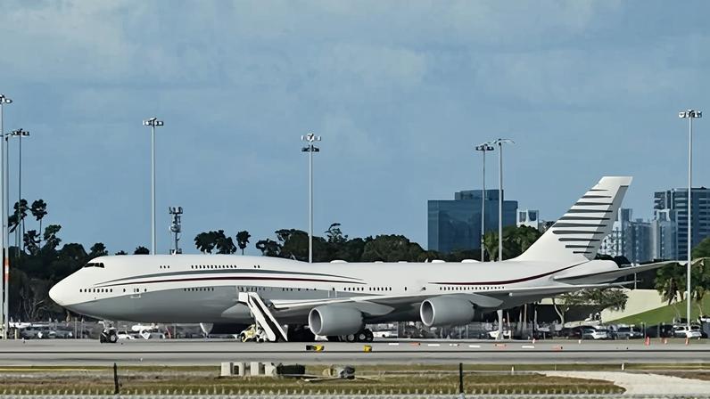 A Qatari Boeing 747 sits on the tarmac of Palm Beach international airport after Donald Trump toured the aircraft on 15 February 2025.