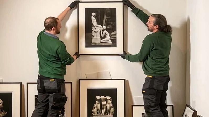 Art handlers test the positioning of a photograph in the forthcoming exhibition of work by Don McCullin.