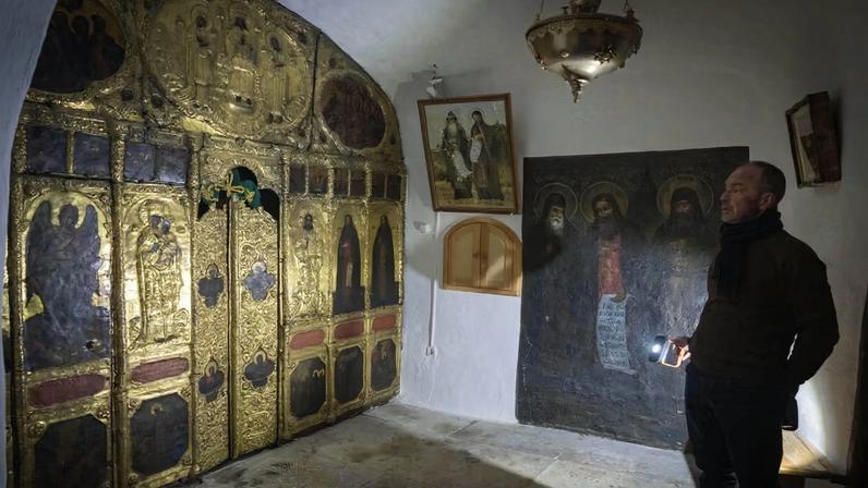A museum employee inspects for damage inside the caves of the Monastery of Caves, a Unesco World Heritage site, after Russian bombings