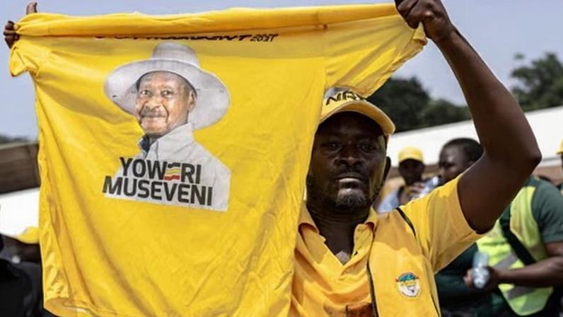 A supporter holds up a T-shirt with a picture of Yoweri Museveni in Kampala.