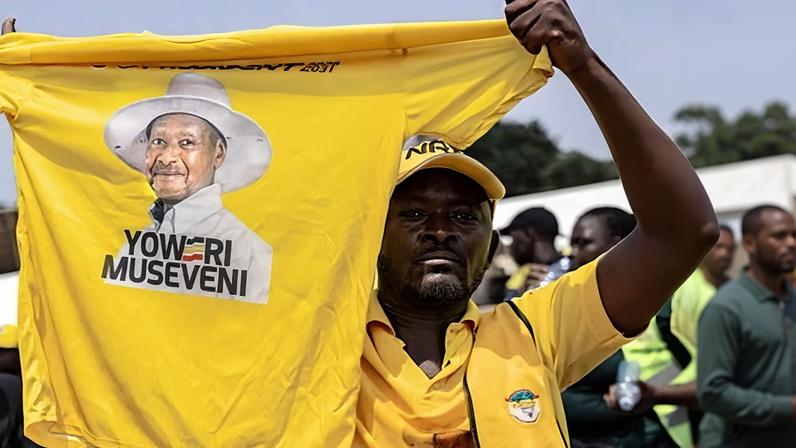 A supporter holds up a T-shirt with a picture of Yoweri Museveni in Kampala.