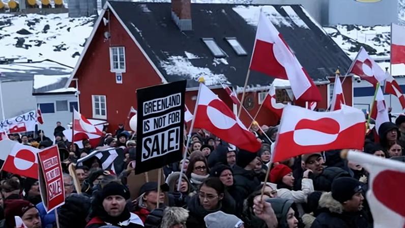 People bear Greenlandic flags as they gather in front of the US consulate to protest against Donald Trump and his announced intent to acquire Greenland.
