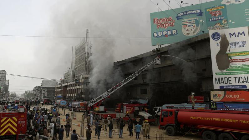 Smoke rises as firefighters spray water to extinguish a massive fire that broke out in the Gul Plaza Shopping Centre building, in Karachi, Pakistan, January 18, 2026. REUTERS/Stringer