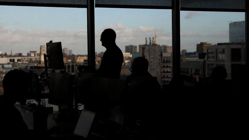Employees work on computers in an office in London, Britain, November 13, 2025. REUTERS/Hannah McKay