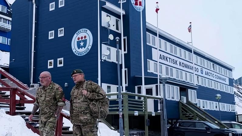 Danish servicemen walk in front of Joint Arctic Command centre in Nuuk, Greenland.