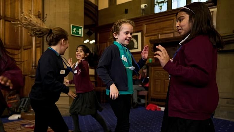 Children dance in a large hall