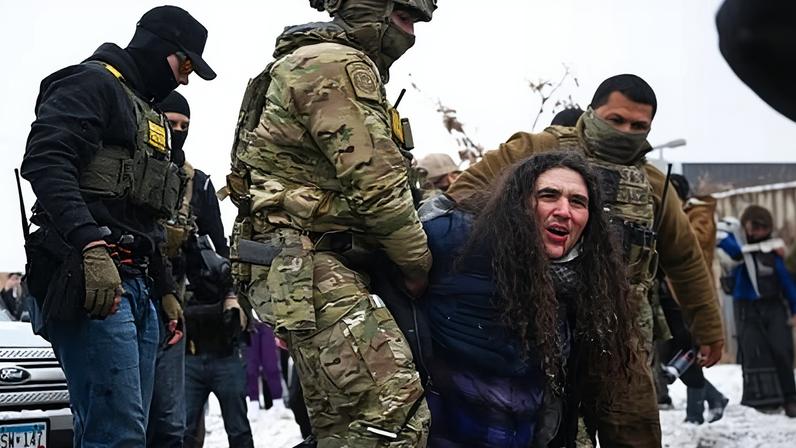 Border patrol agents detain a person in Minneapolis on 21 January 2026.