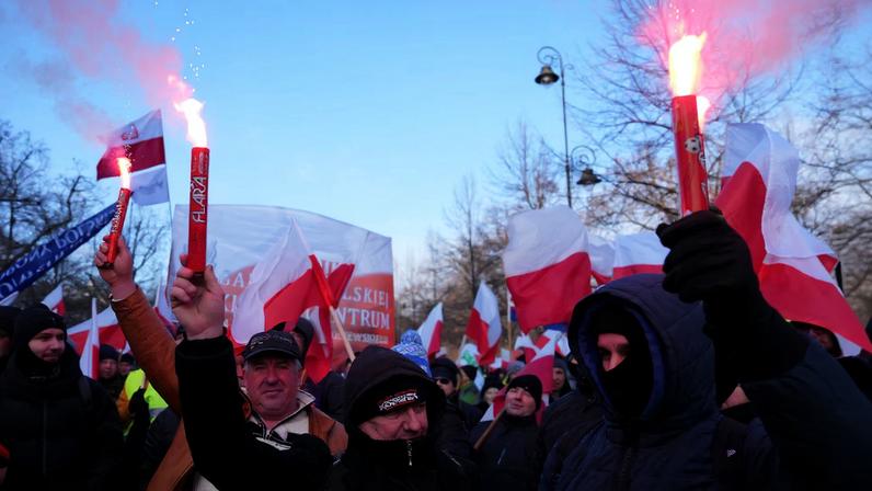 Demonstrators holds flares, as Polish farmers protest against the Mercosur trade deal in Warsaw