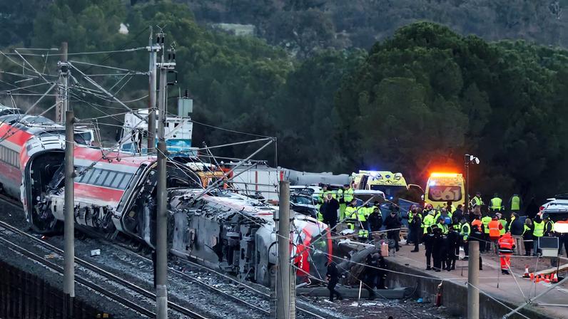 Emergency personnel work next to one of the trains involved in the accident, near Adamuz, in Cordoba, Spain, January 19. REUTERS/Susana Vera