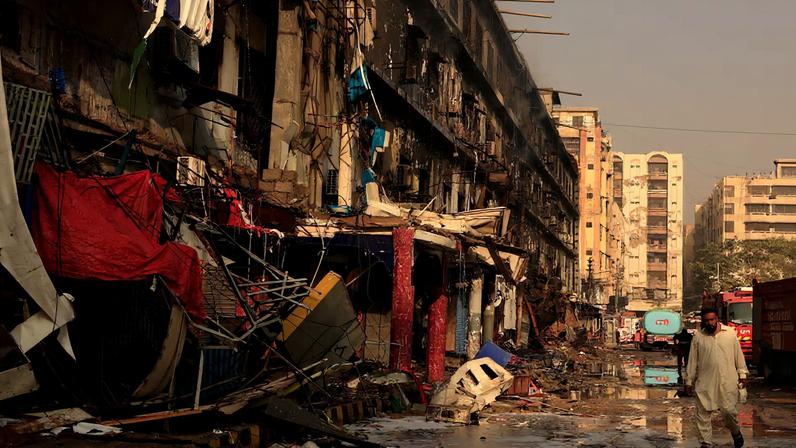 A man moves past debris following a massive fire that broke out in the Gul Plaza Shopping Centre in Karachi, Pakistan, January 19, 2026. REUTERS/Akhtar Soomro