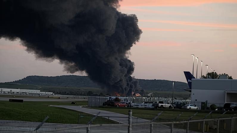 Fire and smoke mark where a UPS cargo plane crashed near Louisville Muhammad Ali international airport on 4 November 2025 in Louisville, Kentucky.