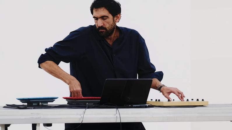 Tarek Atoui performing at the Issey Miyake Spring-Summer 2026 presentation at Centre Pompidou, Paris, in October 2025