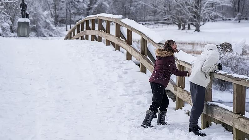 People throw snowballs on a snow-covered bridge in Massachusetts on 19 January