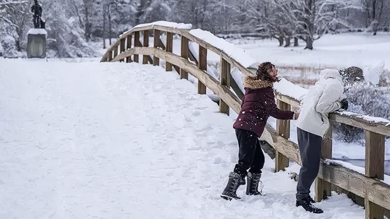 Getty Images People throw snowballs on a snow-covered bridge in Massachusetts on 19 January