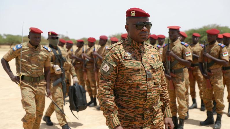 Burkina Faso President Lieutenant Colonel Paul-Henri Damiba is welcomed by soldiers in Dori, Sahel region as he arrives to motivate his troops, after armed men killed civilians and militaries in Seytenga, at an airport in Dori, Burkina Faso June 15, 2022. Burkina Faso's Presidential Press Service/Handout via REUTERS/File Photo
