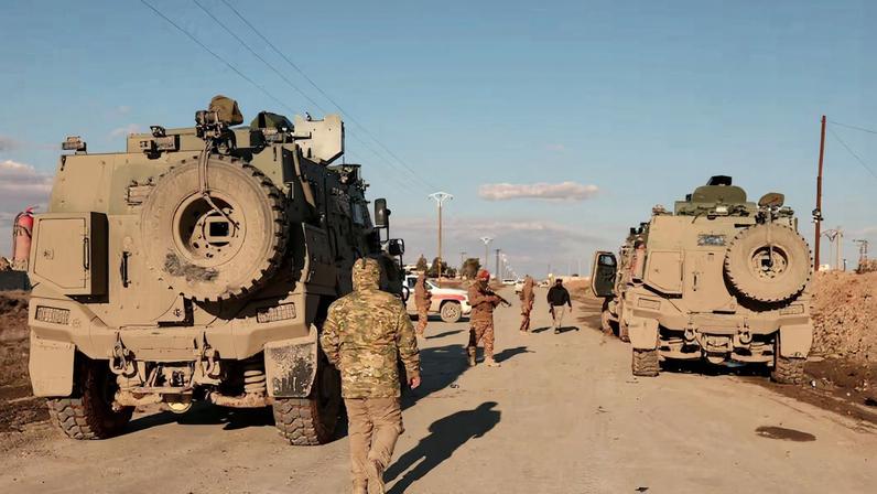 Military members gather near Raqqa prison, where the Syrian army is besieging SDF members after the army took control of the city of Raqqa, Syria January 19, 2026. REUTERS/Mahmoud Hassano/File Photo