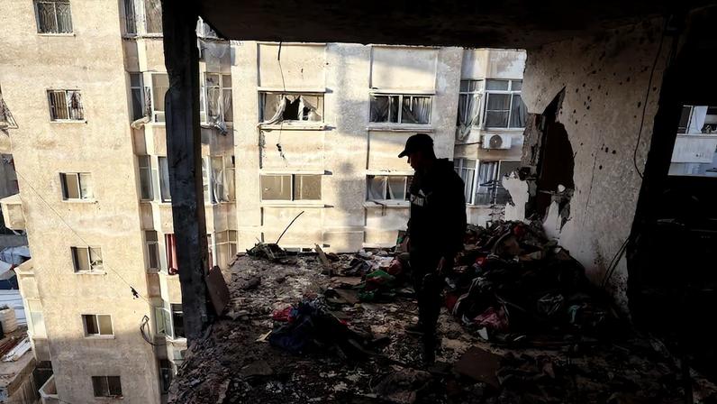 Palestinians inspect the site of an Israeli strike in Gaza City