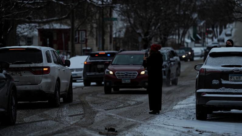 A person records with their phone while ICE agents and other law enforcement officers conduct an immigration raid at a home in St. Paul, Minnesota, U.S., days after an ICE agent fatally shot Renee Nicole Good, January 18, 2026. REUTERS/Leah Millis