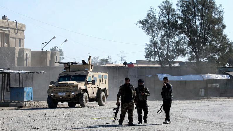 Syrian Democratic Forces (SDF) fighters walk near an armored vehicle, following clashes between SDF and Syrian government forces, in Hasakah, Syria, January 20, 2026. REUTERS/Orhan Qereman