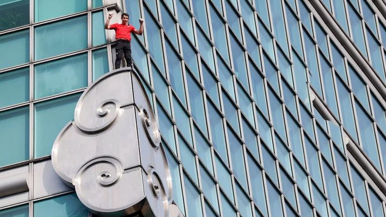 Climber Alex Honnold free soloing Taipei 101 Skyscraper in Taipei
