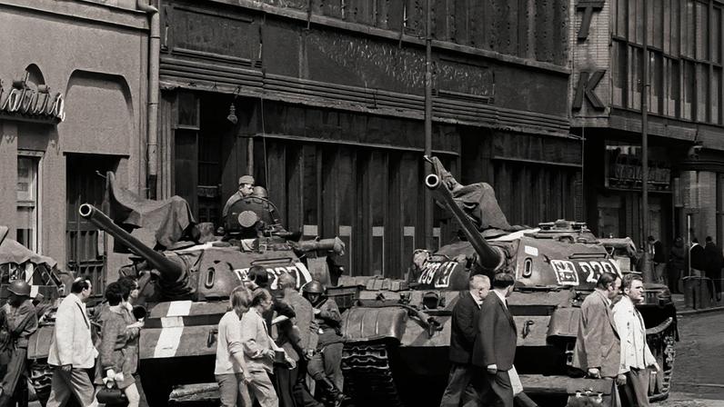 Residents pass Soviet tanks in front of the entrance to the CTK press agency in Prague, Czechoslovakia, on Aug. 29, 1968.