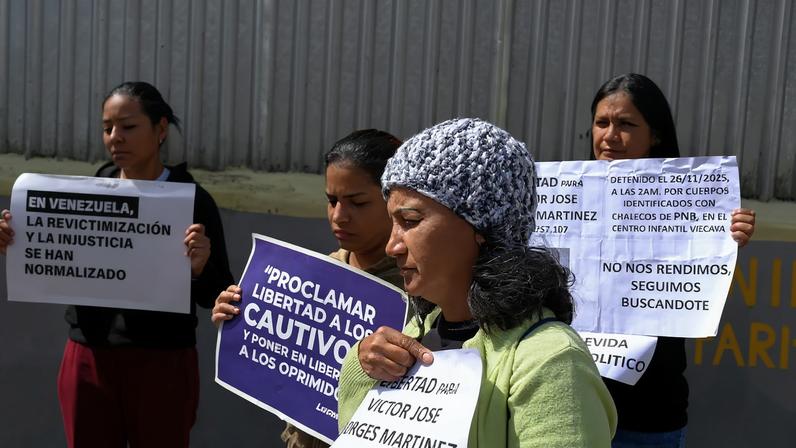 Family members of detainees wait outside the National Police Zone 7 Detention Centre, in Caracas