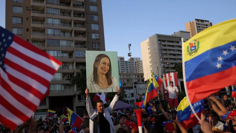 People celebrate after the U.S. struck Venezuela and captured its President Nicolas Maduro and his wife Cilia Flores, in Santiago