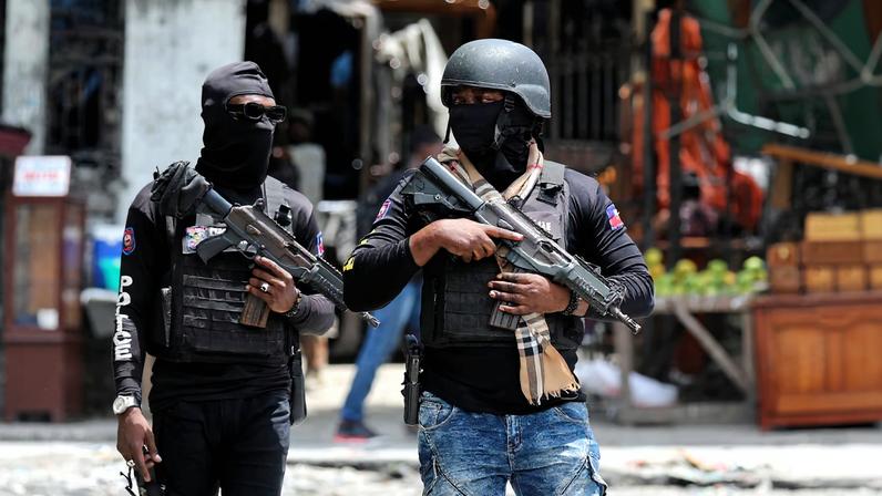 Police officers stand guard in the street, in Port-au-Prince, Haiti May 1, 2024. REUTERS/Ralph Tedy Erol