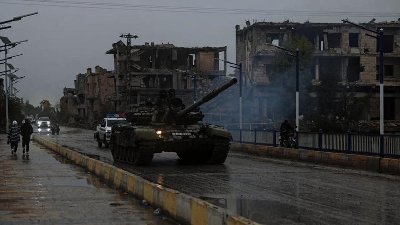 Military personnel sit on top of a tank, after the Syrian Democratic Forces (SDF) withdrew from Deir al-Zor province and the Syrian army took full control over the area, in Deir al-Zor, Syria, January 18, 2026. REUTERS/Khalil Ashawi