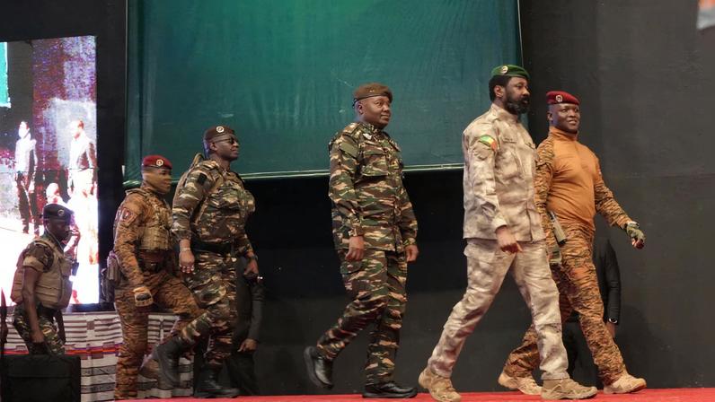 Heads of state of Mali's Assimi Goita, Burkina Faso's Captain Ibrahim Traore and Niger's General Abdourahamane Tiani walk together during the first ordinary summit of heads of state and governments of the Alliance of Sahel States (AES) in Niamey, Niger July 6, 2024. REUTERS/Mahamadou Hamidou