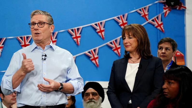 Britain's Chancellor of the Exchequer Rachel Reeves stands next to Prime Minister Keir Starmer