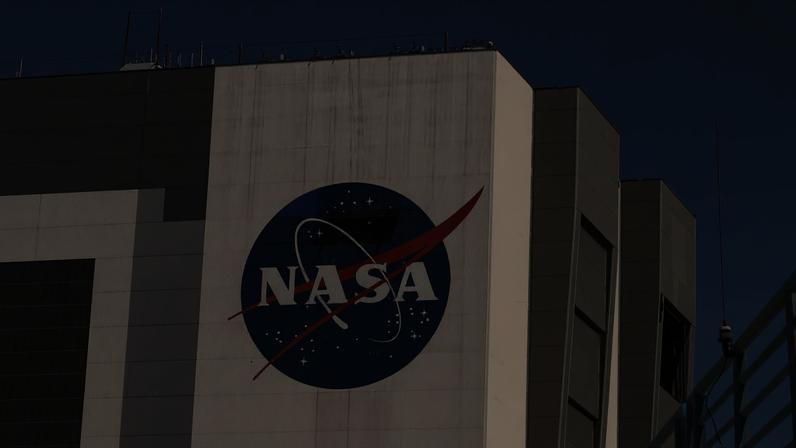 Workers pressure wash the logo of NASA on the Vehicle Assembly Building at the Kennedy Space Center in Cape Canaveral, Florida, U.S., May 19, 2020.