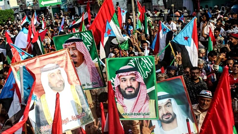 People carry national flags along with portraits of Saudi and Emirati leaders in Aden, Yemen, on Sept. 5, 2019, during a demonstration in support of Saudi Arabia and the United Arab Emirates.