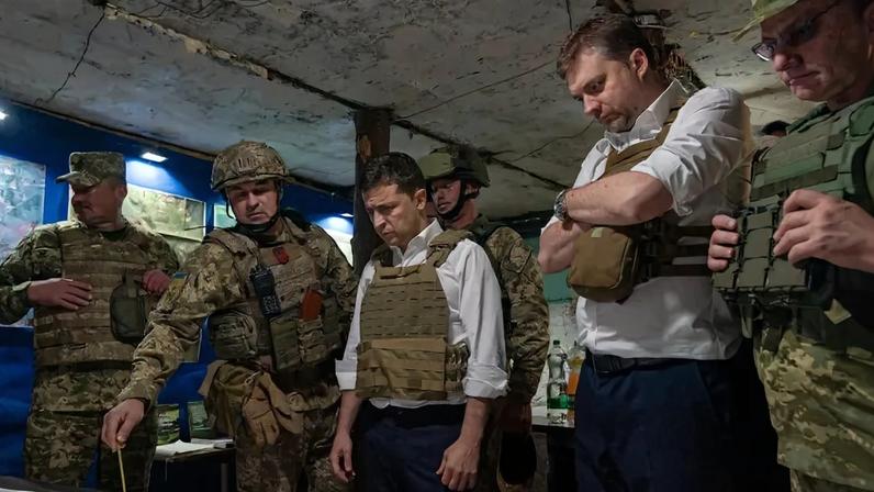 Ukrainian President Volodymyr Zelensky talking with officers at a map during his visit to the Donetsk region on October 14, 2019.
