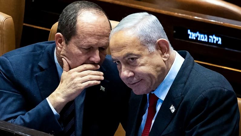 Israel's Economy Minister Nir Barkat (L) speaks with Prime Minister Benjamin Netanyahu at the Knesset in Jerusalem on Feb. 22, 2023.