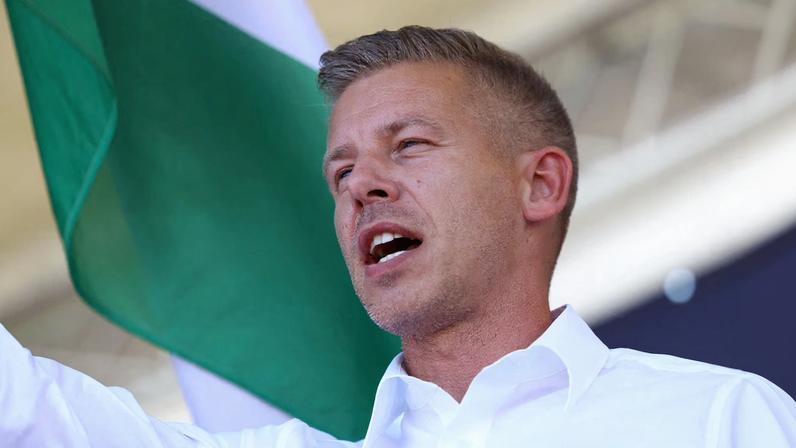Peter Magyar, leader of the opposition Tisza party, waves a Hungarian flag at a rally in Kotcse, Hungary September 7, 2025. REUTERS/Bernadett Szabo/File Photo